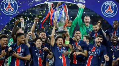 Marquinhos, do Paris Saint-Germain, ergue o troféu enquanto comemora com os companheiros de equipe após vencer a Liga dos Campeões - 31/05/2025 (Foto: REUTERS/Peter Cziborra)